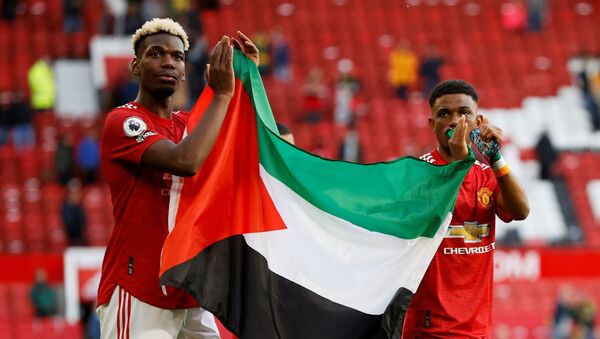 İngiltere Premier Lig ekibi Manchester United oyuncuları Paul Pogba ve Amad Diallo, Fulham maçının ardından Filistin bayrağı açtı. - Sputnik Türkiye