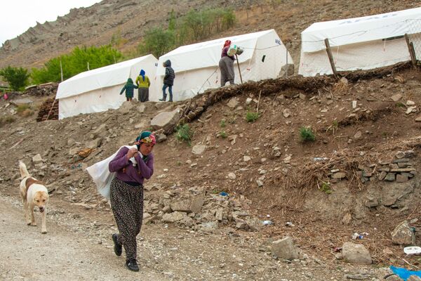  Köyde yaşanan su sıkıntısı nedeniyle kadınlar doldurdukları su bidonlarını çuvala koyarak evlerine taşıyor. - Sputnik Türkiye