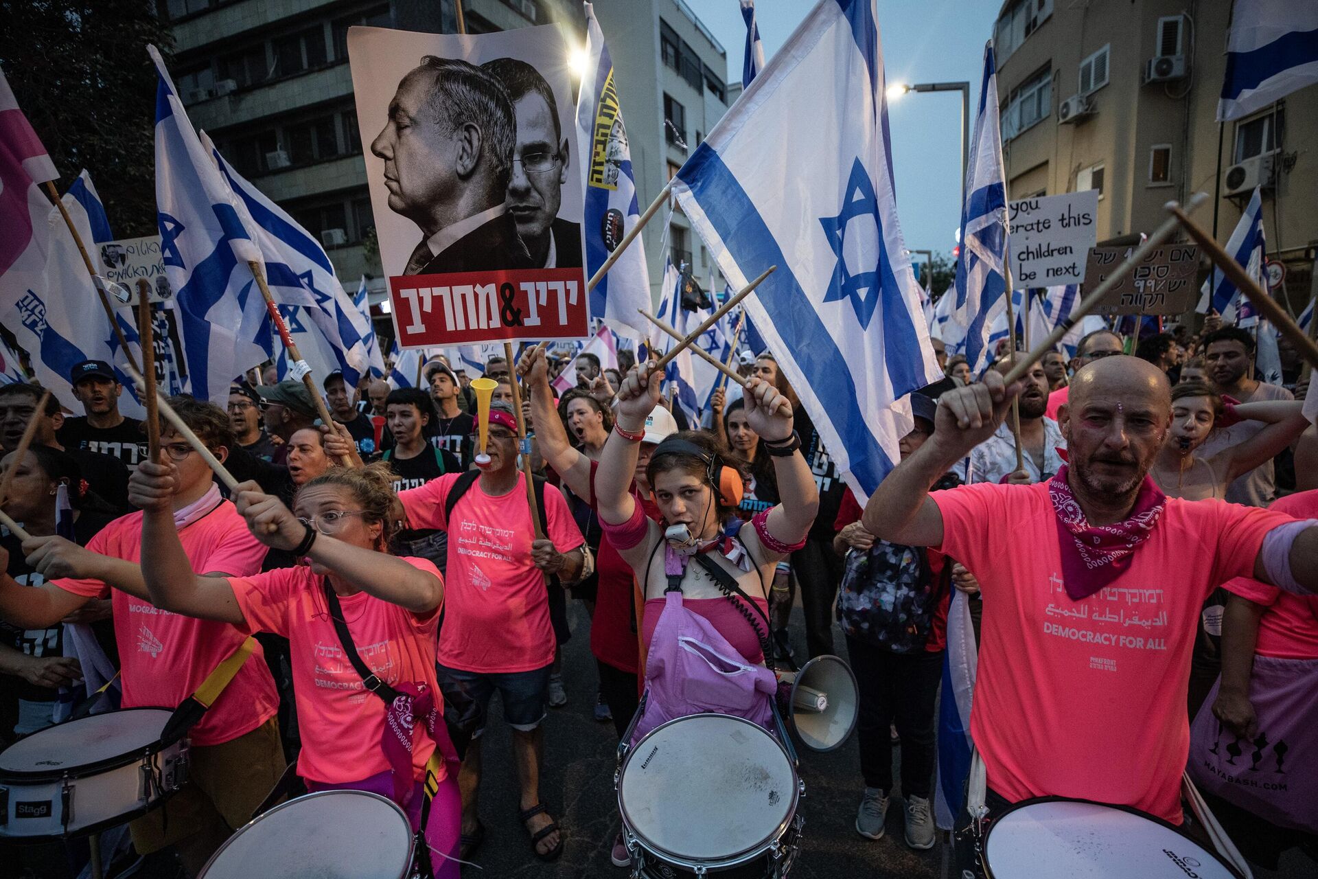 İsrailliler, Başbakan Benyamin Netanyahu öncülüğündeki koalisyon hükümetinin yargının yetkililerini sınırlayan düzenlemesine ve sağ politikalarına yönelik protestolarına devam ediyor. Tel Aviv'de binlerce protestocu, ellerinde İsrail bayraklarıyla sık sık demokrasi sloganları atarak koalisyon hükümetindeki aşırı sağcı politikacıları eleştiren dövizler taşıdı.  - Sputnik Türkiye, 1920, 27.05.2023