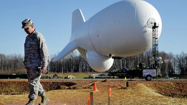 NORAD's Air Force Col. Chuck Douglass walks in front of an unmanned aerostat that is part of a new U.S. military cruise-missile defense system during a media preview, Wednesday, Dec. 17, 2014, in Middle River, Md. Military officials said a pair of helium-filled aerostats stationed in Maryland are intended provide early detection of cruise missiles over a large swath of the East Coast, from Norfolk, Va., to upstate New York, during a three-year test. JLENS, short for Joint Land Attack Cruise Missile Defense Elevated Netted Sensor System, will be fully implemented this winter. - Sputnik Türkiye