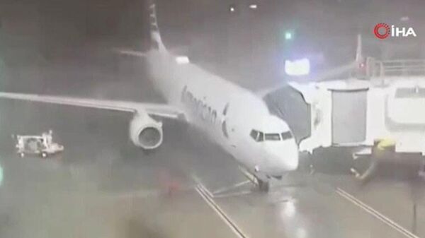 ABD'deki Dallas Fort Worth Havalimanı'nda park halindeki yolcu uçağı fırtınanın etkisi ile döndü. - Sputnik Türkiye