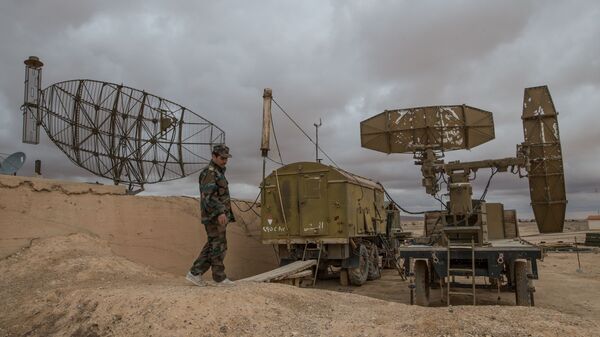 A Syrian army soldier inspects radar equipment at the Syrian Air Force base in Homs - Sputnik Türkiye