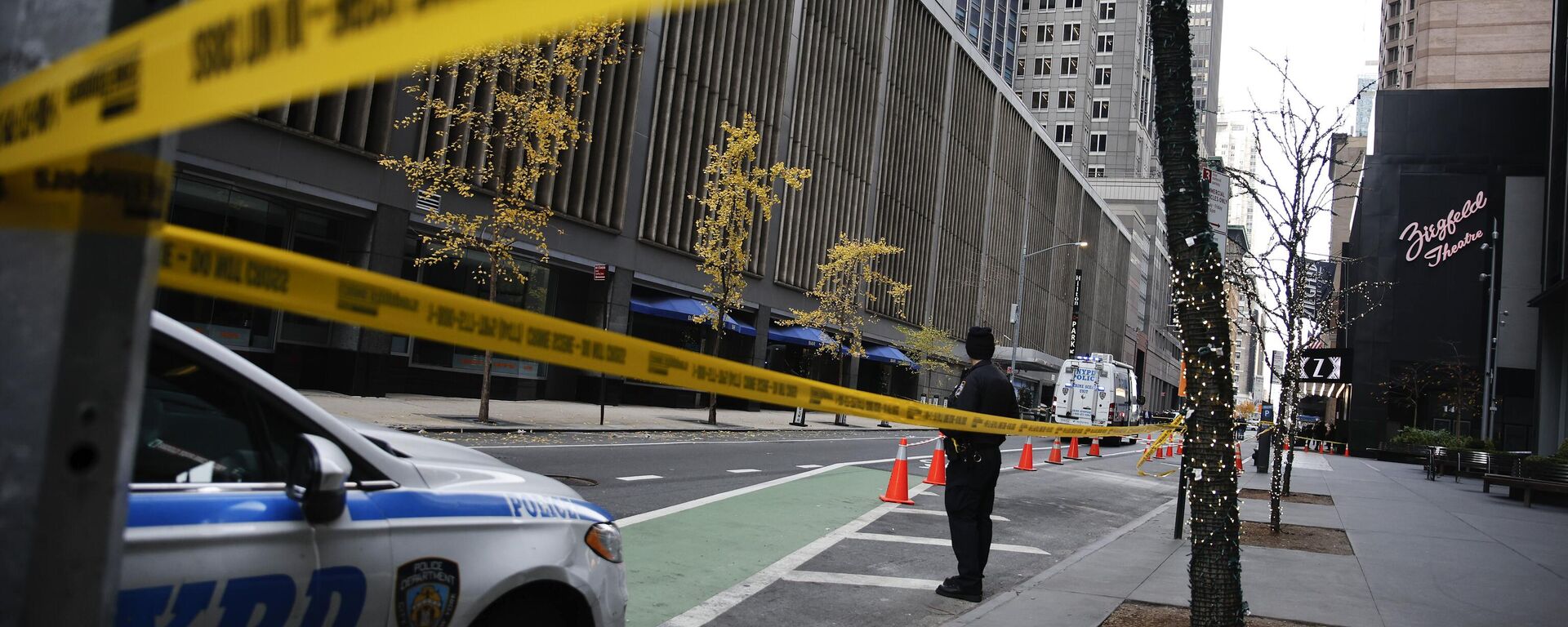 A New York police officer stands on 54th Street outside the Hilton Hotel in midtown Manhattan where Brian Thompson, the CEO of UnitedHealthcare, was fatally shot Wednesday, Dec. 4, 2024, in New York. (AP Photo/Stefan Jeremiah) - Sputnik Türkiye, 1920, 09.12.2024