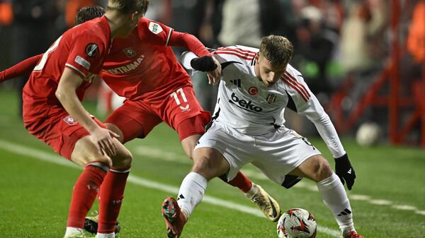 UEFA Avrupa Ligi sekizinci hafta maçında, Twente ile Beşiktaş takımları Enschede şehrindeki De Grolsch Veste Stadı'nda karşı karşıya geldi. Karşılaşmada, Beşiktaş takımının futbolcusu Semih Kılıçsoy (sağda), rakibi Daan Rots (ortada) ile mücadele etti. - Sputnik Türkiye