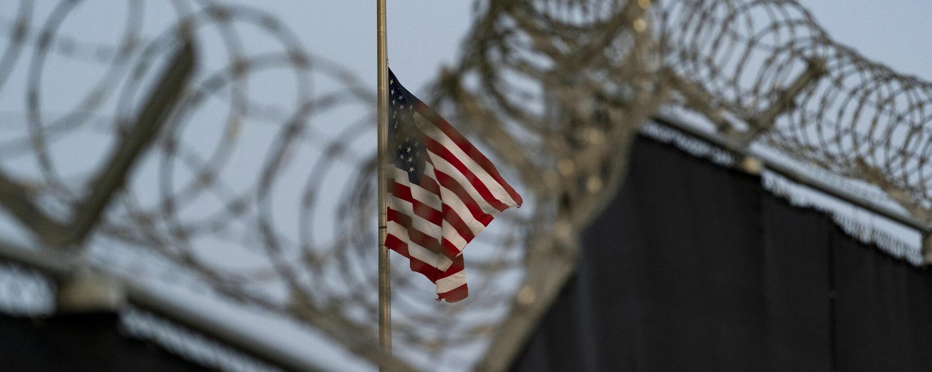 US flag flies at half-staff as seen from Camp Justice in Guantanamo Bay Naval Base, Cuba, Aug. 29, 2021. - Sputnik Türkiye, 1920, 05.02.2025