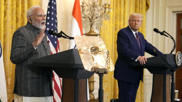 India's Prime Minister Narendra Modi speaks as President Donald Trump listens during a news conference in the East Room of the White House, Thursday, Feb. 13, 2025, in Washington. - Sputnik Türkiye