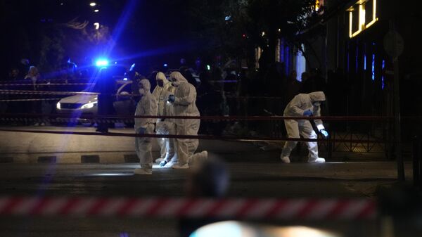 Police officers from the forensics department check the area after a bomb explosion outside of the Hellenic Train offices the company that runs Greece's railway, in Athens, Greece, Friday, April 11, 2025. - Sputnik Türkiye