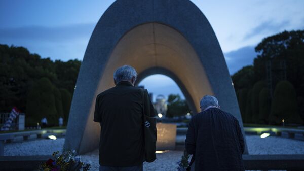 People pray for the atomic bomb victims in front of the Memorial Cenotaph ahead of the memorial service to mark the 80th anniversary of the WWII U.S. atomic bombing in Hiroshima, Wednesday, Aug. 6, 2025, in Japan. - Sputnik Türkiye