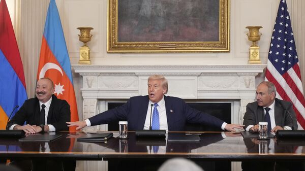 President Donald Trump, center, joined by Armenian Prime Minister Nikol Pashinyan, right, and Azerbaijan President Ilham Aliyev, speaks during a trilateral signing ceremony in the State Dining Room of the White House, Friday, Aug. 8, 2025, in Washington. (AP Photo/Mark Schiefelbein) - Sputnik Türkiye