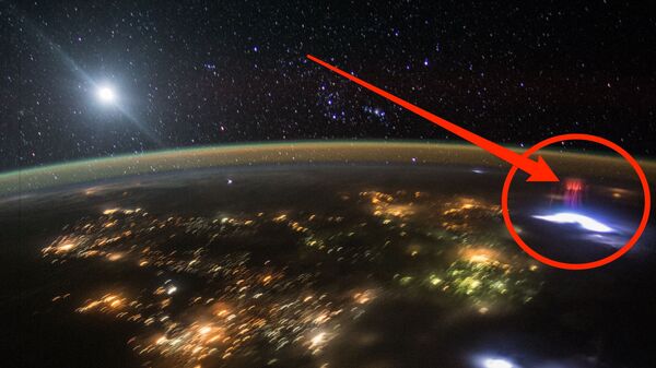 This photo, taken by an astronaut traveling over Central America in the International Space Station, captures a red sprite formed over a thunderstorm. - Sputnik Türkiye