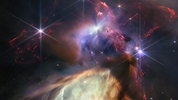 The first anniversary image from NASA’s James Webb Space Telescope displays star birth like it’s never been seen before, full of detailed, impressionistic texture. The subject is the Rho Ophiuchi cloud complex, the closest star-forming region to Earth. It is a relatively small, quiet stellar nursery, but you’d never know it from Webb’s chaotic close-up. Jets bursting from young stars crisscross the image, impacting the surrounding interstellar gas and lighting up molecular hydrogen, shown in red. Some stars display the telltale shadow of a circumstellar disk, the makings of future planetary systems. - Sputnik Türkiye