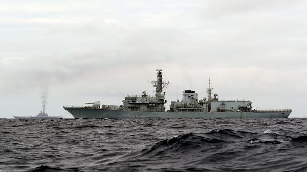 This is a handout photo issued by Britain's Ministry of Defence taken on Wednesday Oct. 19, 2016, of HMS Richmond, foreground, a Type 23 Duke Class frigate, observing aircraft carrier Admiral Kuznetsov, at rear left, which is part of a Russian task group, during transit through the North Sea - Sputnik Türkiye