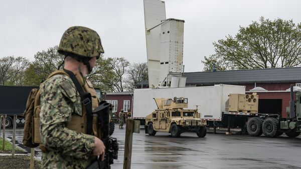 BORNHOLM, Denmark (May 6, 2024) - U.S. Navy Equipment Operator Constructionman Grant Sanford, assigned to Naval Mobile Construction Battalion (NMCB) 11, stands guard over a containerized missile launcher during a rehearsal in Bornholm, Denmark, May 6, 2024. - Sputnik Türkiye