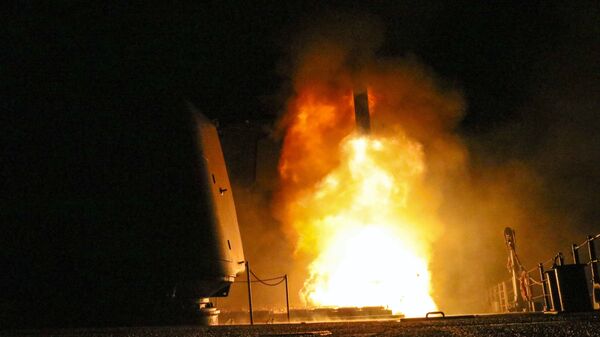 In this image provided by the U.S. Navy, the guided-missile cruiser USS Monterey (CG 61) fires a Tomahawk land attack missile Saturday, April 14, 2018, as part of the military response to Syria's alleged use of chemical weapons on April 7.  - Sputnik Türkiye