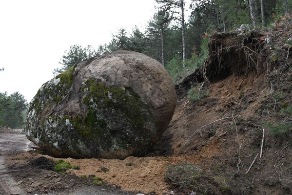 Kayanın daha önce yolun üst kısmında bulunduğunu söyleyen Tunçer depremin ardından yola kaymış olabileceğini ifade etti. - Sputnik Türkiye