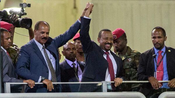 In this Sunday July 15, 2018 file photo, Eritrean President Isaias Afwerki, second left, and Ethiopia's Prime Minister Abiy Ahmed, center, hold hands as they wave at the crowds in Addis Ababa, Ethiopia. Once official rivals, the leaders of Ethiopia and Eritrea have embraced warmly to the roar of a crowd of thousands at a concert celebrating the end of a long state of war. The 2019 Nobel Peace Prize was given to Ethiopian Prime Minister Abiy Ahmed on Friday Oct. 11, 2019. - Sputnik Türkiye