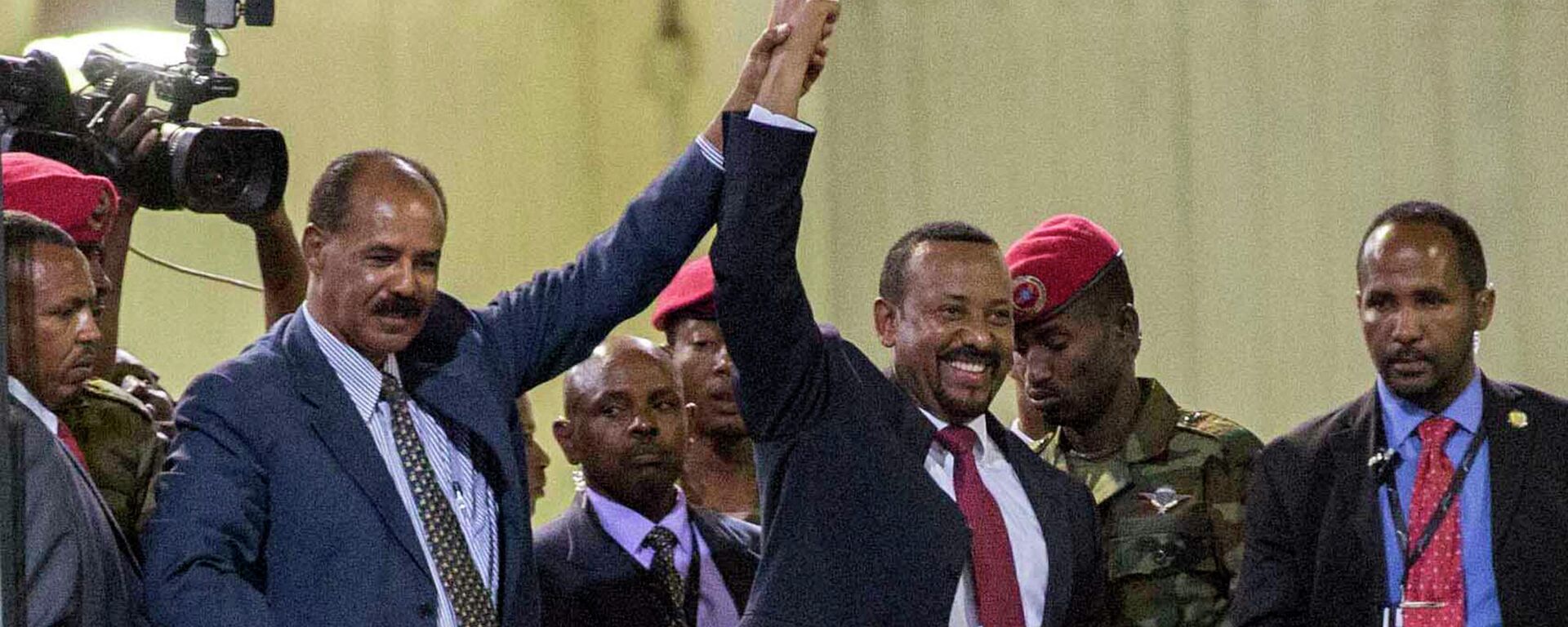 In this Sunday July 15, 2018 file photo, Eritrean President Isaias Afwerki, second left, and Ethiopia's Prime Minister Abiy Ahmed, center, hold hands as they wave at the crowds in Addis Ababa, Ethiopia. Once official rivals, the leaders of Ethiopia and Eritrea have embraced warmly to the roar of a crowd of thousands at a concert celebrating the end of a long state of war. The 2019 Nobel Peace Prize was given to Ethiopian Prime Minister Abiy Ahmed on Friday Oct. 11, 2019. - Sputnik Türkiye, 1920, 06.11.2025