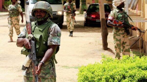 In this Thursday, June 6, 2013 file photo Nigerian soldiers stand guard at the offices of the state-run Nigerian Television Authority in Maiduguri, Nigeria - Sputnik Türkiye
