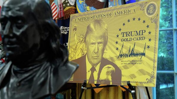 Trump Gold Card is pictured as President Donald Trump speaks in the Oval Office - Sputnik Türkiye