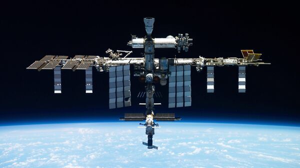 This undated photo provided by Roscosmos shows the International Space Station. On Monday, Oct. 9, 2023, the Russian space agency said there was a leak in a backup coolant line for a new science lab at the station, but the crew and station aren't in danger - Sputnik Türkiye