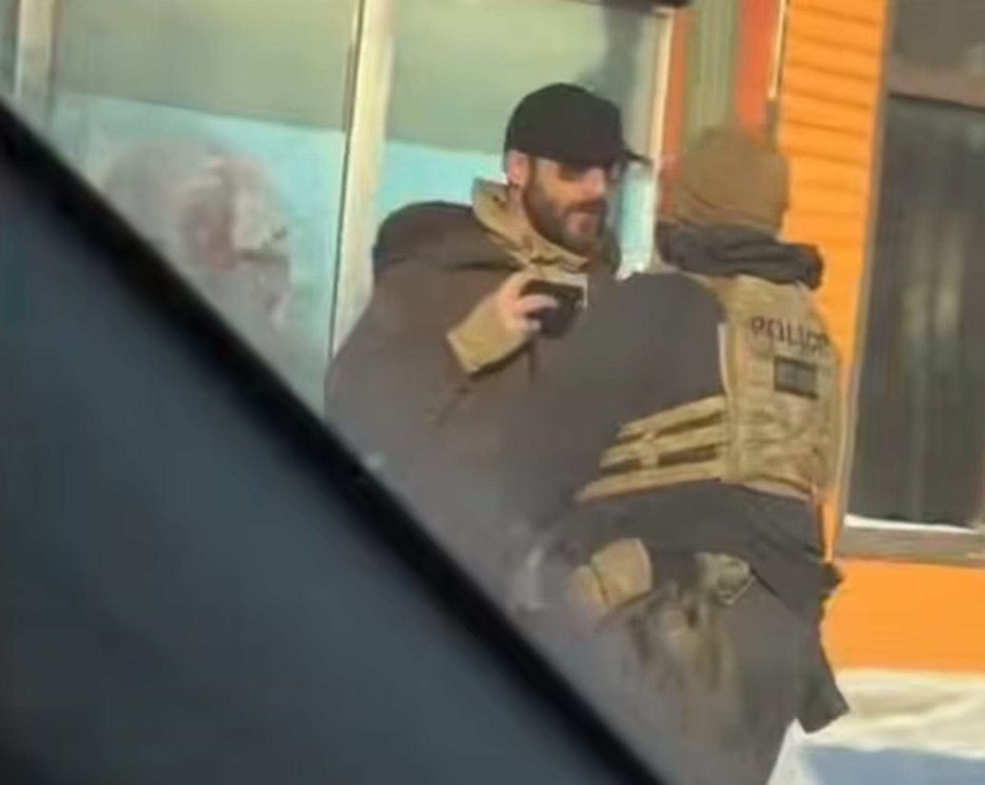 A still image of Alex Pretti recording video on his phone as he was shoved back by a federal agent minutes before being shot and killed. Photograph: Minneapolis resident who asked to be identified as Jessie - Sputnik Türkiye, 1920, 25.01.2026