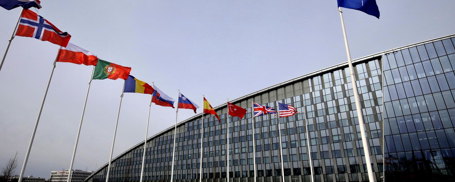 Flags of Alliance members flap in the wind outside NATO headquarters in Brussels, Friday, Feb. 28, 2020.  - Sputnik Türkiye, 1920, 10.02.2026