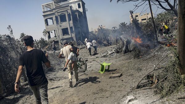 Palestinians evacuate from a site hit by an Israeli bombardment on Khan Younis, southern Gaza Strip, Saturday, July 13, 2024 Palestinians evacuate from a site hit by an Israeli bombardment on Khan Younis, southern Gaza Strip, Saturday, July 13, 2024 - Sputnik Türkiye