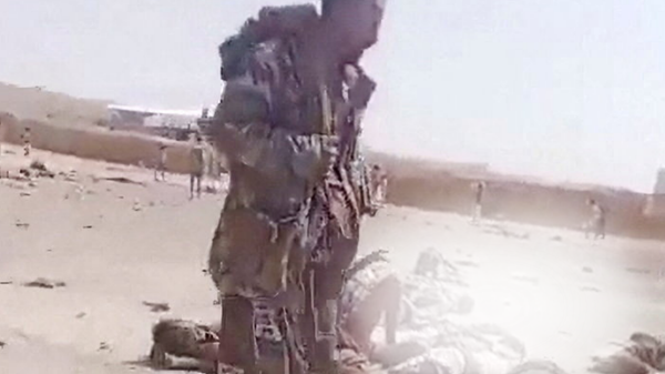 A screengrab from a video shows a person walking near bodies in the aftermath of a Houthi attack on Yemeni government military camp in Shabwa, Yemen, October 19, 2026. - Sputnik Türkiye