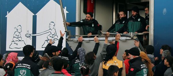 İHH, Suriye'deki kampta evlerinden kaçan Suriyelilere yiyecek dağıtıyor. - Sputnik Türkiye