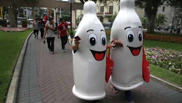 Two women dressed as condoms walk during an awareness program on International Condom Day in Lima, Peru. - Sputnik Türkiye