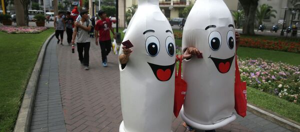 Two women dressed as condoms walk during an awareness program on International Condom Day in Lima, Peru. - Sputnik Türkiye