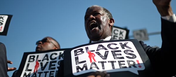 Men holding signs reading Black Lives Matter march in the 30th annual Kingdom Day Parade in honor of Dr. Martin Luther King Jr. - Sputnik Türkiye