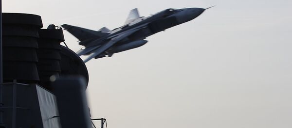 An undated US Navy picture shows what appears to be a Russian Sukhoi SU-24 attack aircraft making a very low pass close to the U.S. guided missile destroyer USS Donald Cook in the Baltic Sea. - Sputnik Türkiye