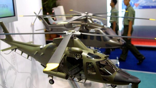 Army personnels walk past models of combat helicopters on display at the Defense Services Asia exhibition in Kuala Lumpur. (File) - Sputnik Türkiye