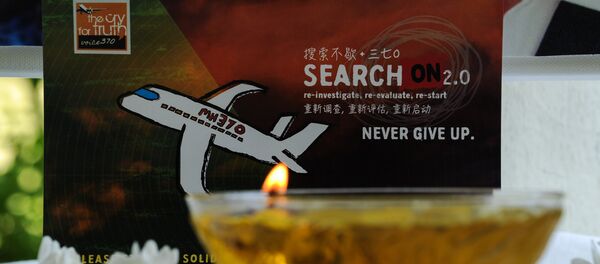 A candle burns a prayer message for passengers of missing Malaysia Airlines flight MH370 in Petaling Jaya on March 8, 2016 - Sputnik Türkiye