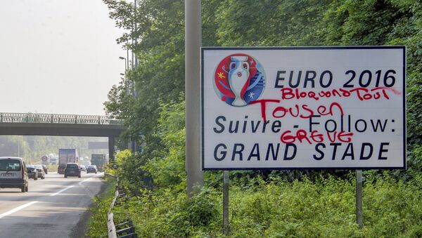 This picture taken on June 6, 2016 shows a tagged road board reading Let's block everything, all on strike over an exit road indication to a Euro 2016 stadium on the circular road of Lille, northern France 3 days before the beginning of the Euro 2016 championship. - Sputnik Türkiye