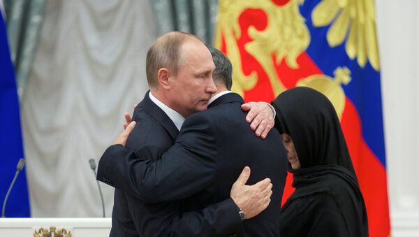 Kremlin Sarayı’nda düzenlenen törende Rusya Devlet Başkanı Vladimir Putin, kahramanın Kızıl Yıldız madalyasını polisin babası ve annesine teslim etti. - Sputnik Türkiye