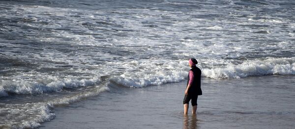 A Moroccan woman wearing a burkini, a full-body swimsuit designed for Muslim women, enters the sea at Oued Charrat beach, near the capital Rabat - Sputnik Türkiye
