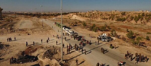 Law enforcement officers near cars and ambulances in a humanitarian corridor for civilians and militants along the Castello Road in northern Aleppo, Syria Law enforcement officers near cars and ambulances in a humanitarian corridor for civilians and militants along the Castello Road in northern Aleppo, Syria - Sputnik Türkiye