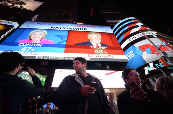 ABD'liler New York'taki Times Meydanı'na kurulan ekranda seçim sonuçlarını izliyor. - Sputnik Türkiye