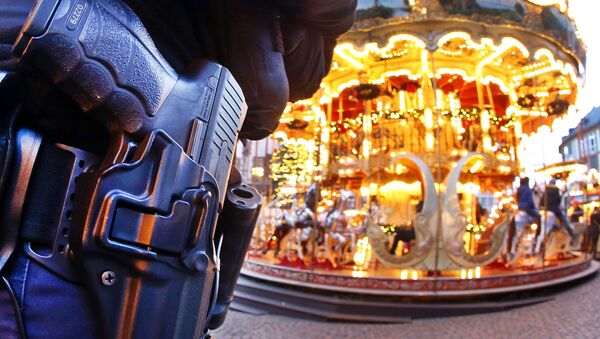A German police officer stands next to a merry-go-round in the Christmas market in Frankfurt, Germany, Tuesday, Dec. 20, 2016 one day after a truck ran into a crowded Christmas market in Berlin killing several people - Sputnik Türkiye