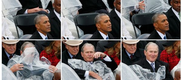 Görevi 2009'da Barack Obama'ya devreden Bush ise yağmurdan korunmak için başına örttüğü muşambayla fotoğrafçıların ilgisini çekti. - Sputnik Türkiye