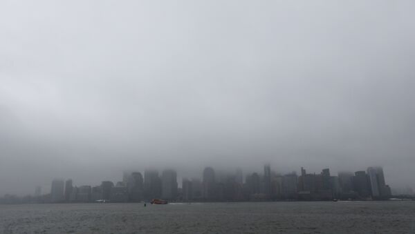 A boat chugs along the Hudson River as fog and clouds blanket over the New York City Skyline seen from Liberty State Park, Wednesday, Dec. 23, 2015, in Jersey City, N.J - Sputnik Türkiye