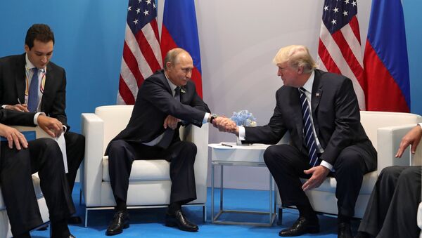Russian President Vladimir Putin and President of the USA Donald Trump, right, talk during their meeting on the sidelines of the G20 summit in Hamburg - Sputnik Türkiye