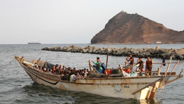 African illegal immigrants sit on a boat in the southern port city of Aden on September 26, 2016, before being deported to Somalia - Sputnik Türkiye