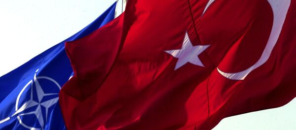 A Turkish flag waves in front of NATO's one - Sputnik Türkiye