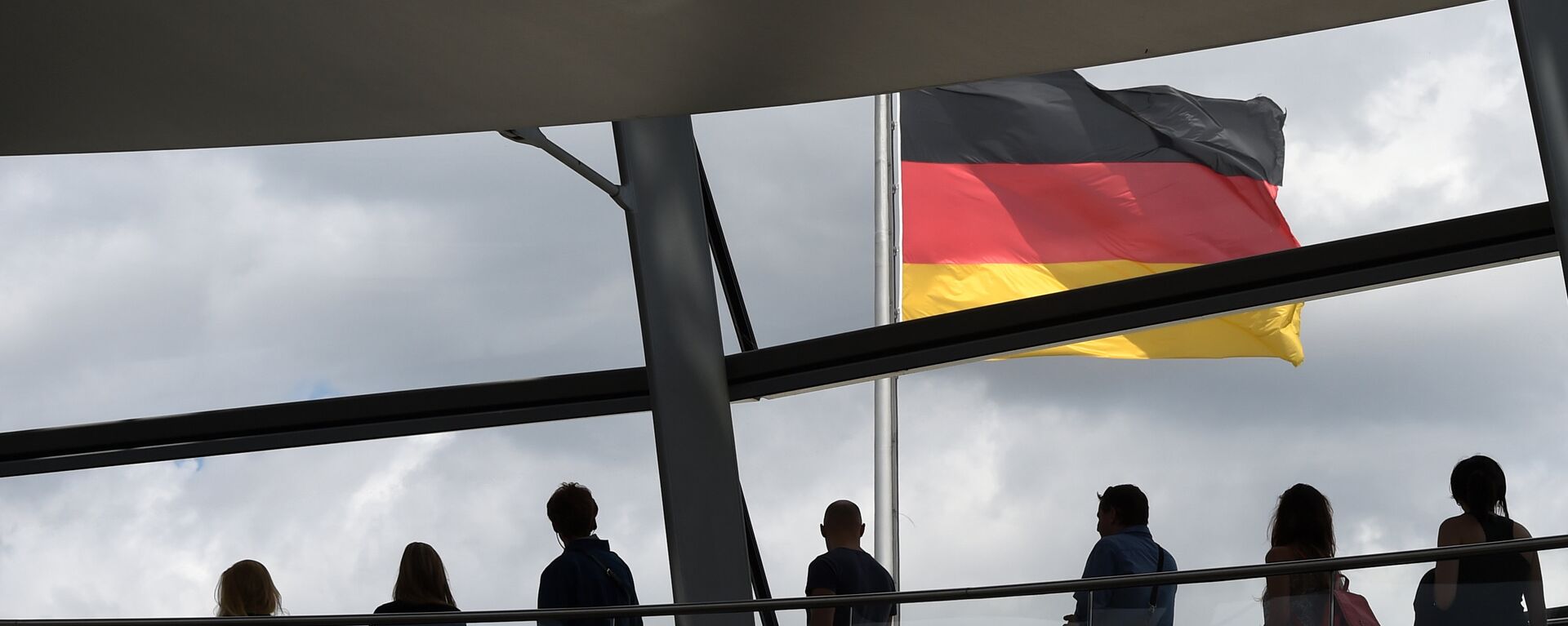 Visitors walk in the glass cupola of the Reichstag building that hosts the German parliament (Bundestag) and look at a German flag in Berlin, Germany, on June 10, 2016. - Sputnik Türkiye, 1920, 12.08.2022