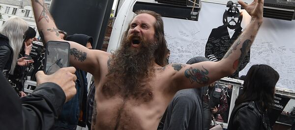 Motorhead'in solisti Lemmy Kilmister portresinin önünde bir hayran - Sputnik Türkiye