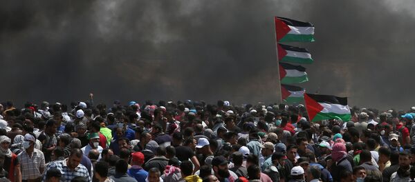 Palestinian demonstrators gather during a protest against U.S. embassy move to Jerusalem and ahead of the 70th anniversary of Nakba, at the Israel-Gaza border in the southern Gaza Strip May 14, 2018 - Sputnik Türkiye