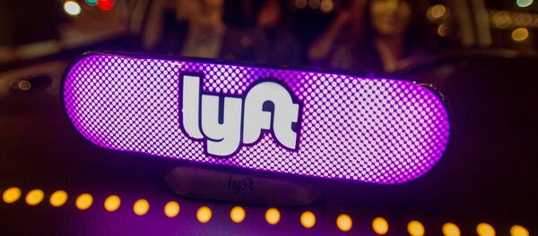 In this image distributed on Thursday, Feb. 9, 2017, Lyft's new Amp glows on the dashboard of a car in San Francisco. - Sputnik Türkiye